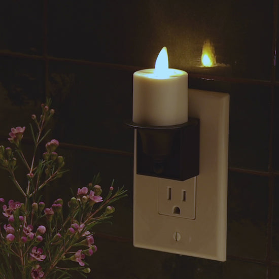 a video demonstrating luminara's bronze candle night light