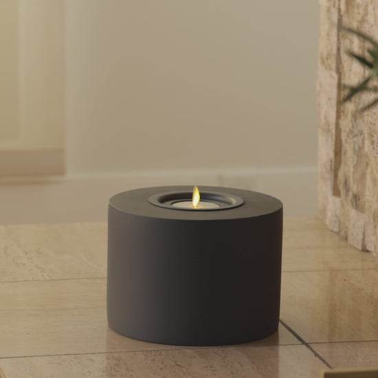 a video demonstrating luminara's concrete candle holder