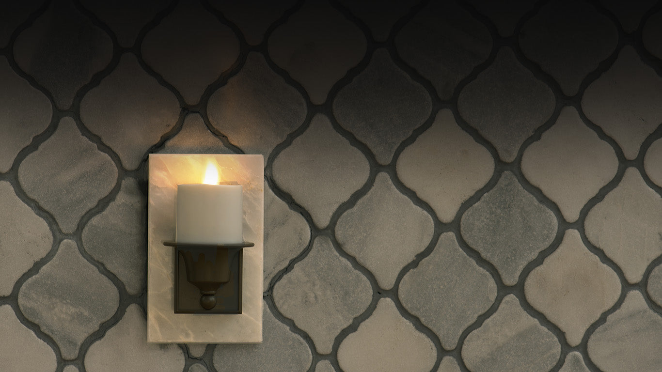 Luminara Flameless candle nightlight against a patterned wall